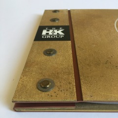 Corporate Anniversary Book with Custom Treated Metal Covers and Hardware and Screen Printed Logos